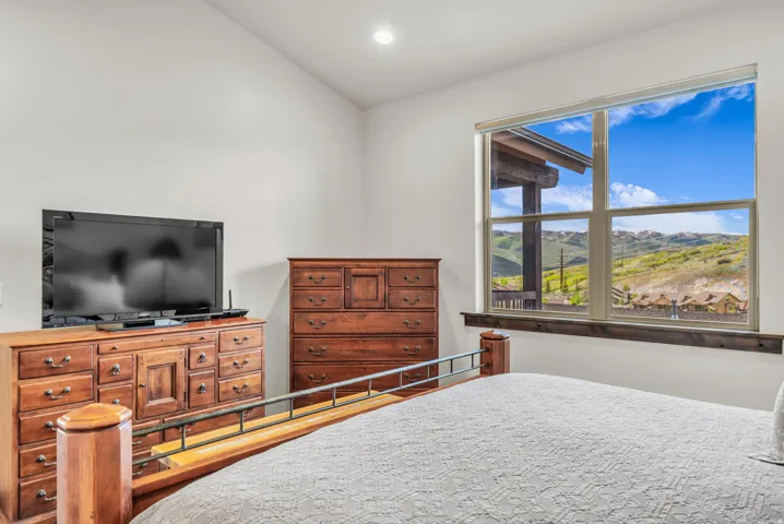 Expansive window overlooking distant mountains and additional properties