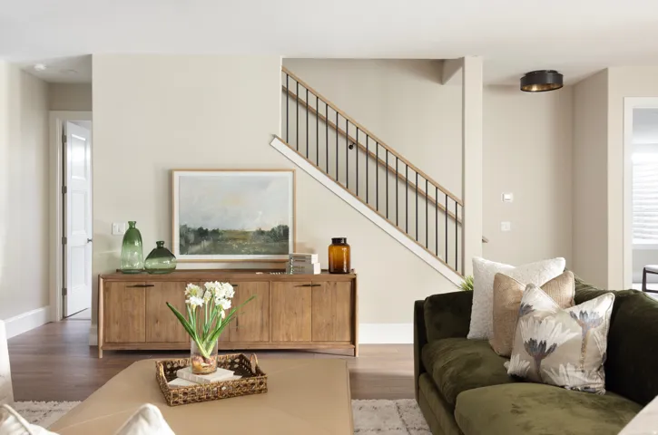 Staircase featuring dark metal balusters and light wood handrails