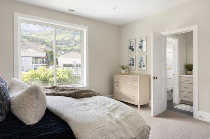 Expansive window overlooking distant mountains and surrounding properties