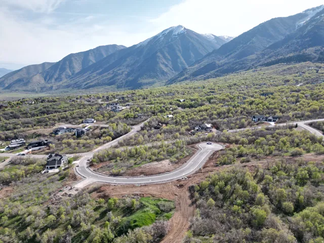 Expansive mountain setting featuring a paved road system and wooded terrain