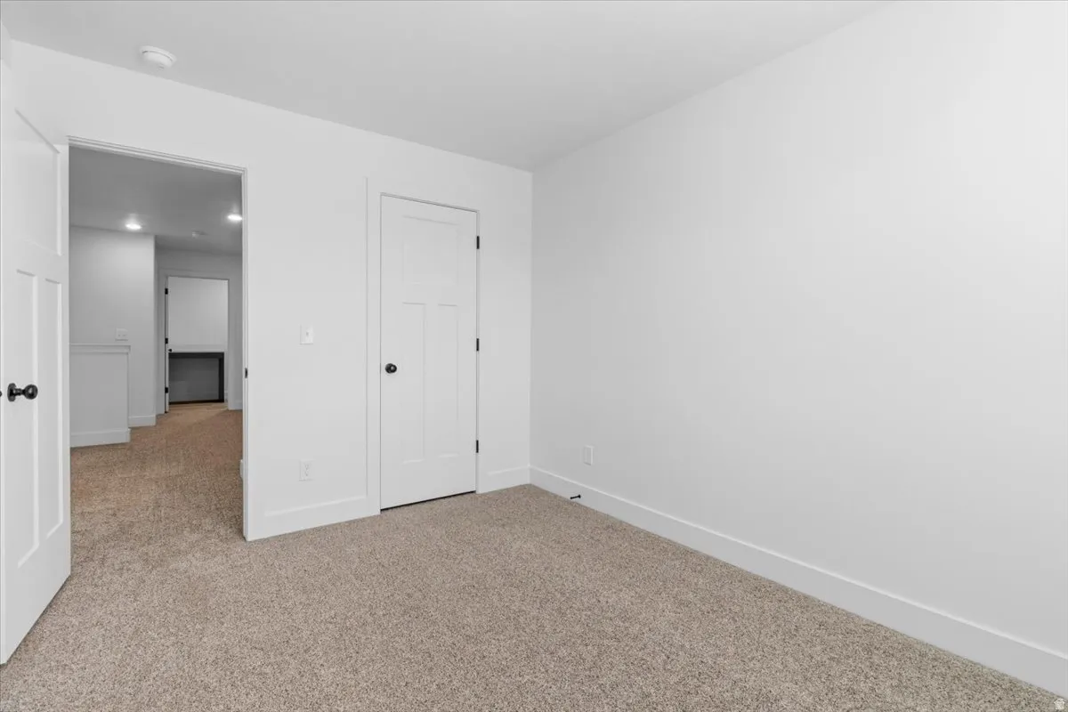 Neutral tone carpeting and bright white walls