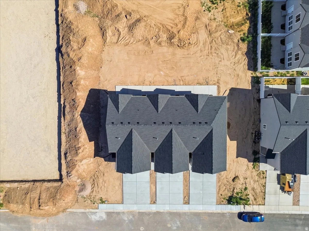 Aerial perspective showcasing a new construction duplex with dark shingle roofing