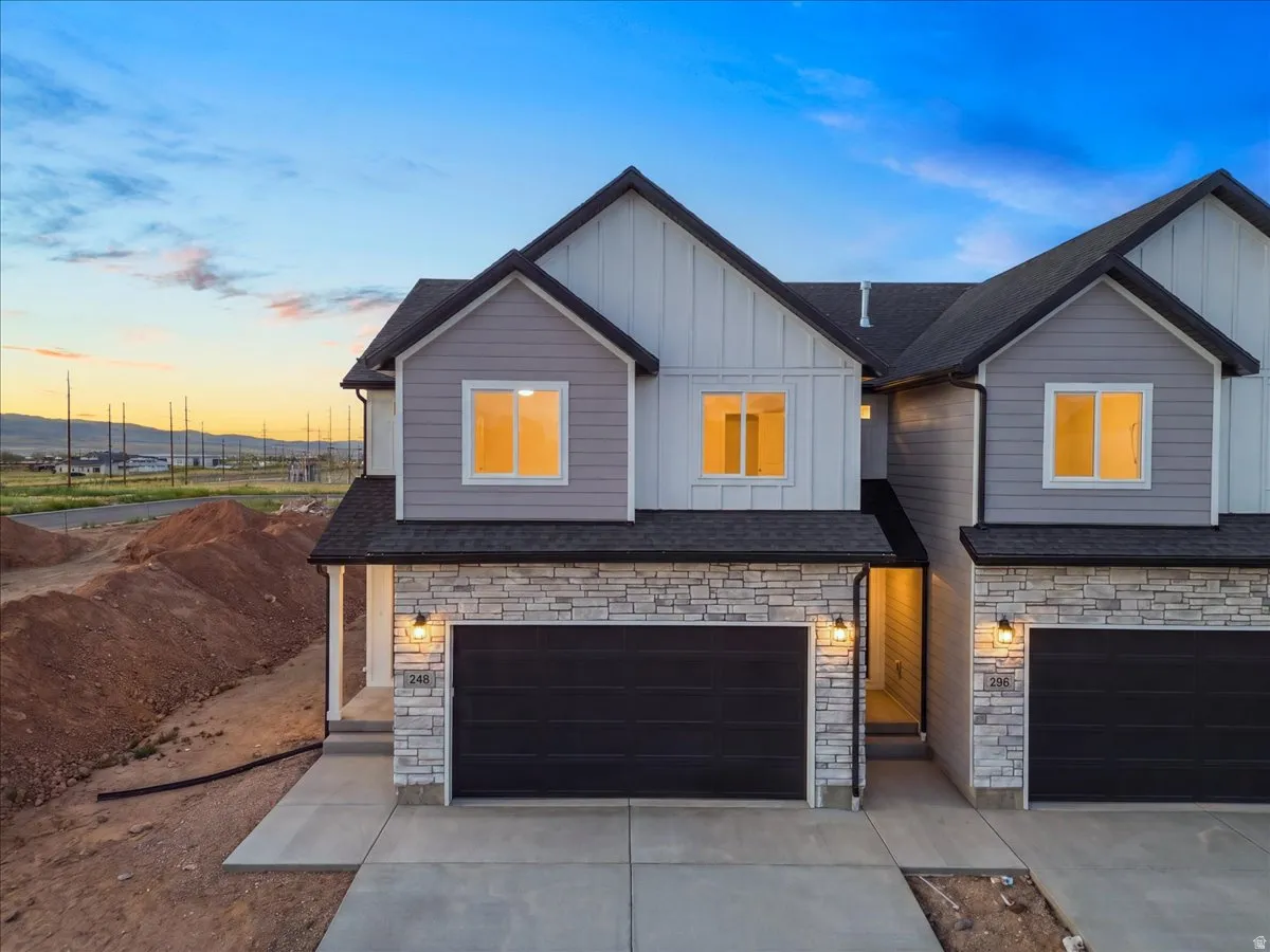 Modern exterior featuring a combination of horizontal siding, vertical board and batten siding, and stacked stone accents