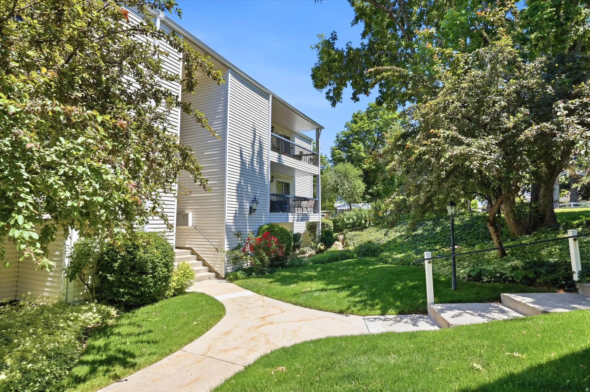 Multi-story building exterior with horizontal siding and multiple balconies