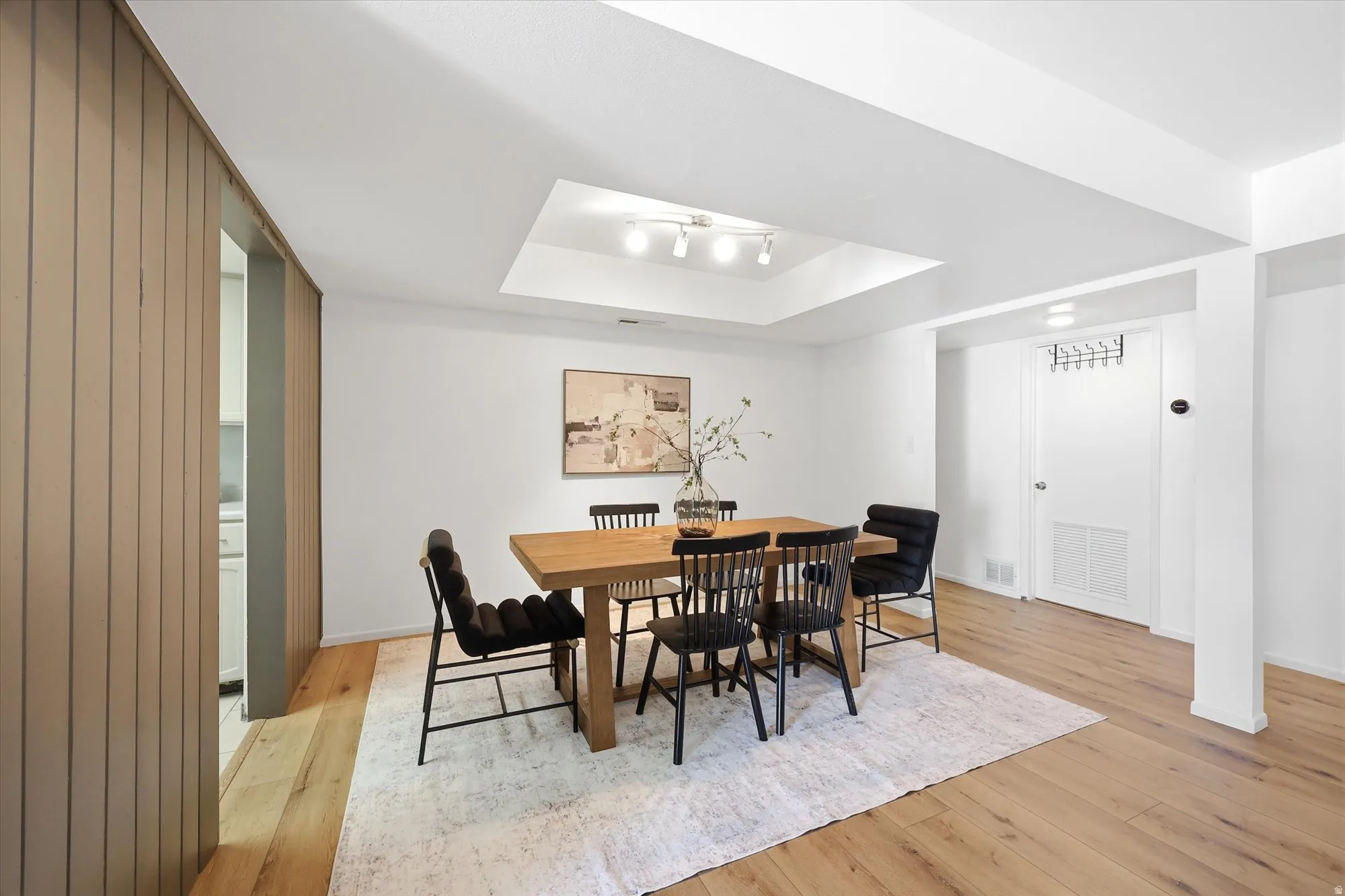 Recessed ceiling with track lighting above the dining space