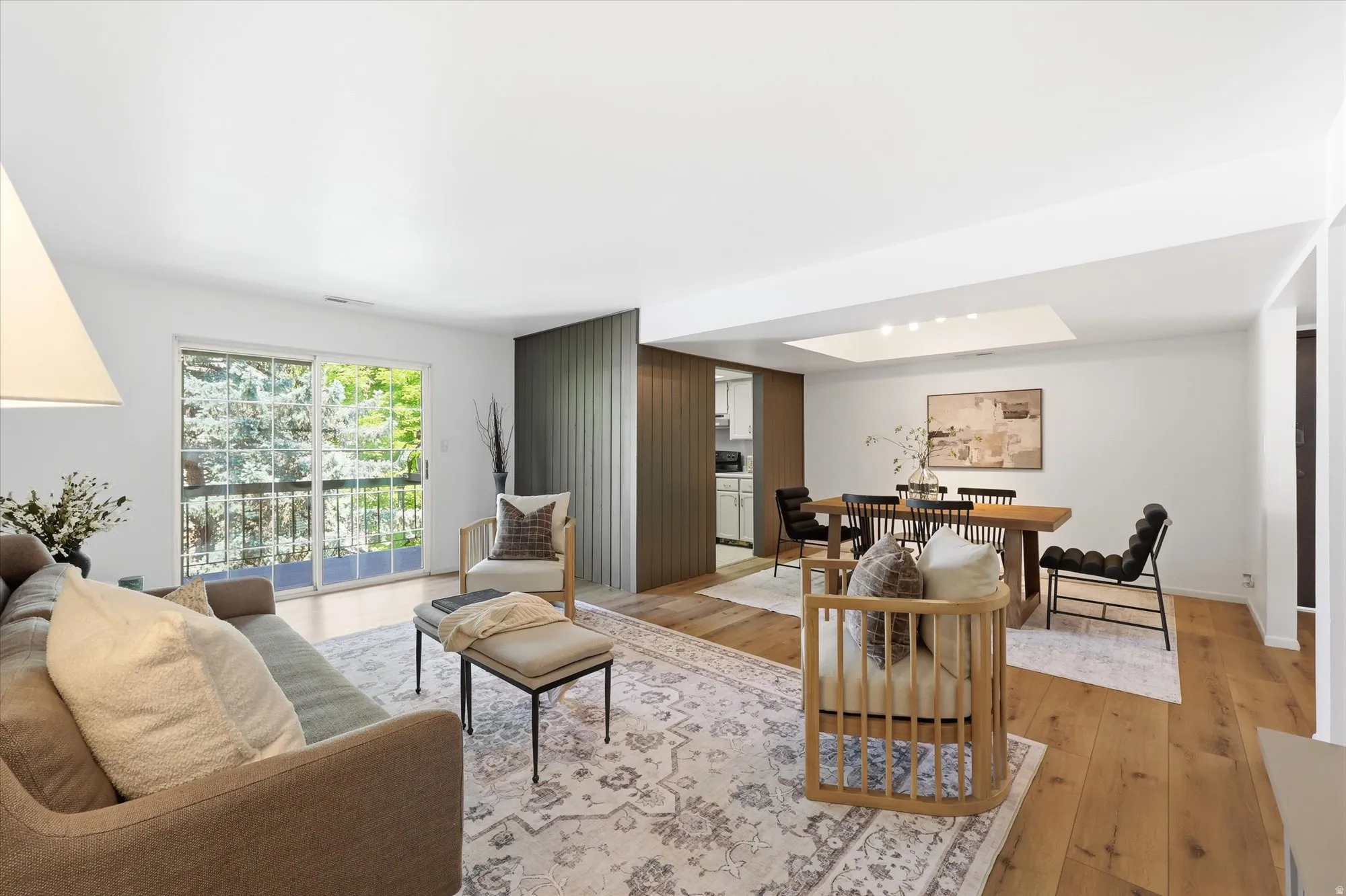 Bright living space featuring wood-finish flooring and a neutral color palette