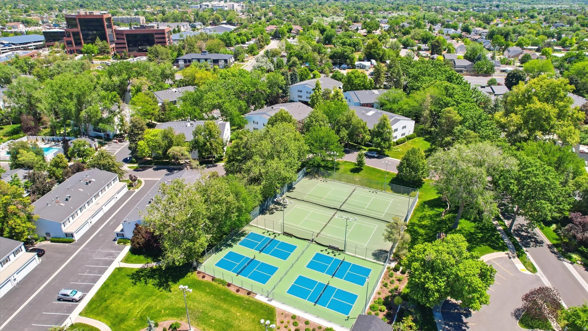 Expansive athletic courts featuring two tennis courts and four pickleball courts