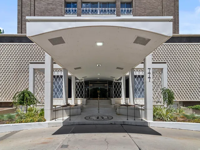Covered entrance with recessed lighting and a paved driveway