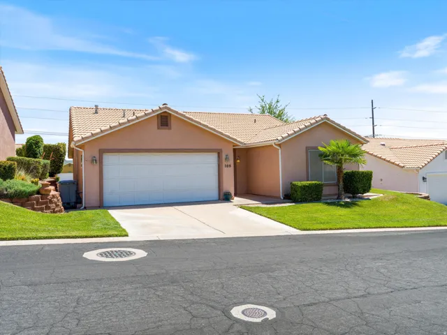 Single-story residence featuring a stucco exterior, concrete tile roof, and an attached two-car garage