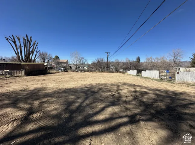 Expansive cleared lot with visible fencing along the perimeter