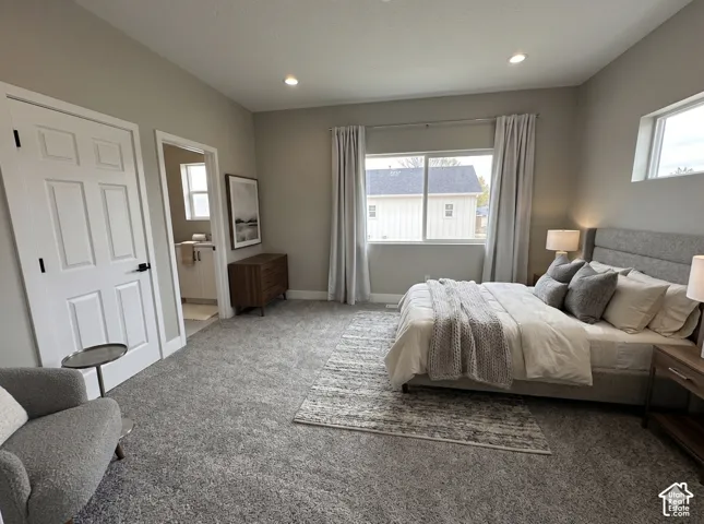 Spacious bedroom featuring plush gray carpeting, recessed lighting, and multiple windows providing ambient illumination  Virtually Staged to give you an idea of space planning