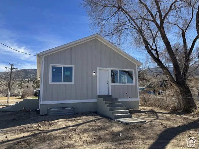 Light gray vertical siding exterior with white trim