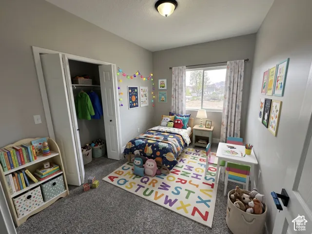 Carpeted room featuring a single window with curtain rods, a flush-mount ceiling light fixture, bi-fold closet doors, and light gray wall paint ( Virtually Staged to give you an idea of space planning)