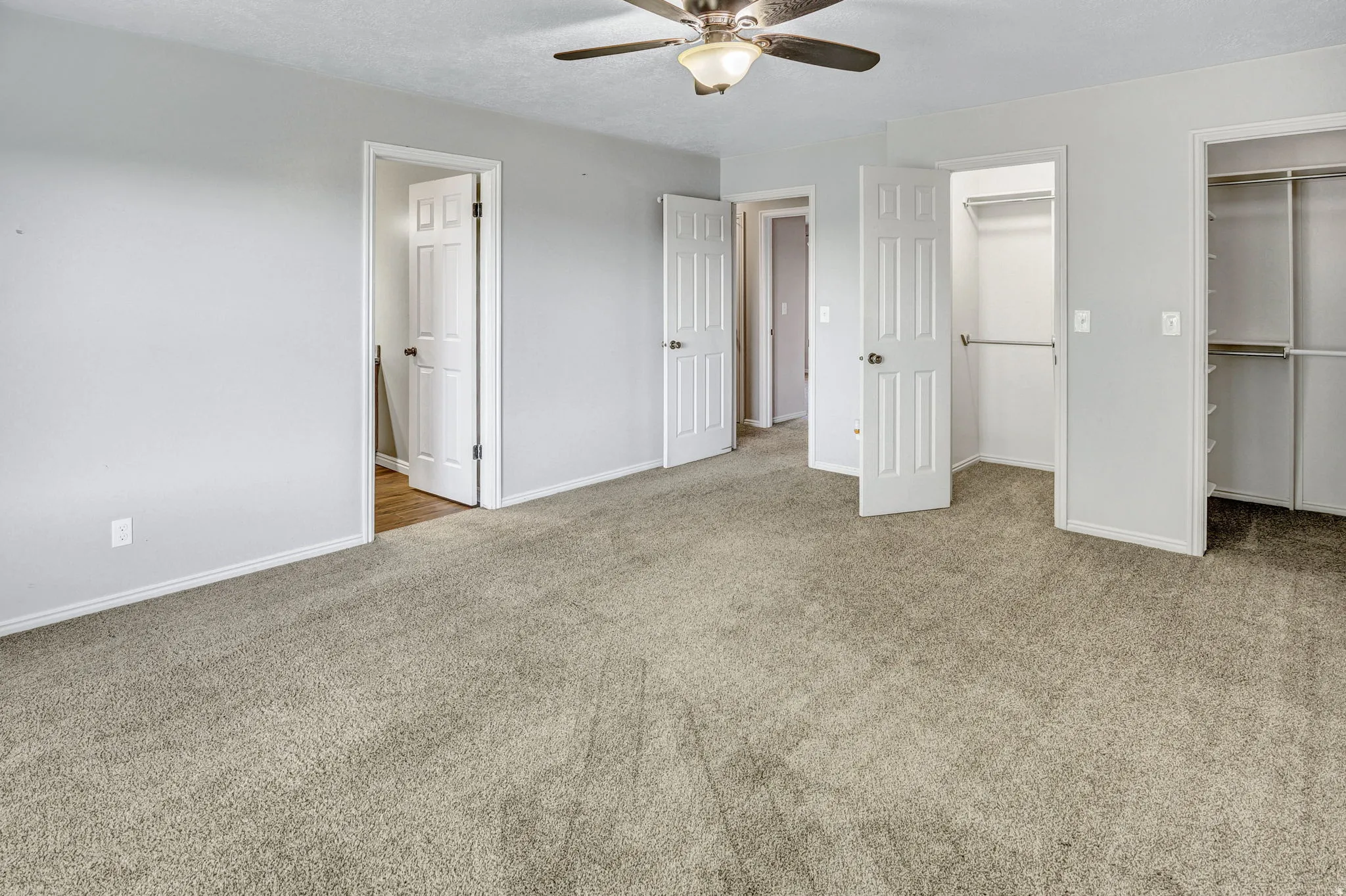 Spacious room featuring neutral carpet and light gray walls