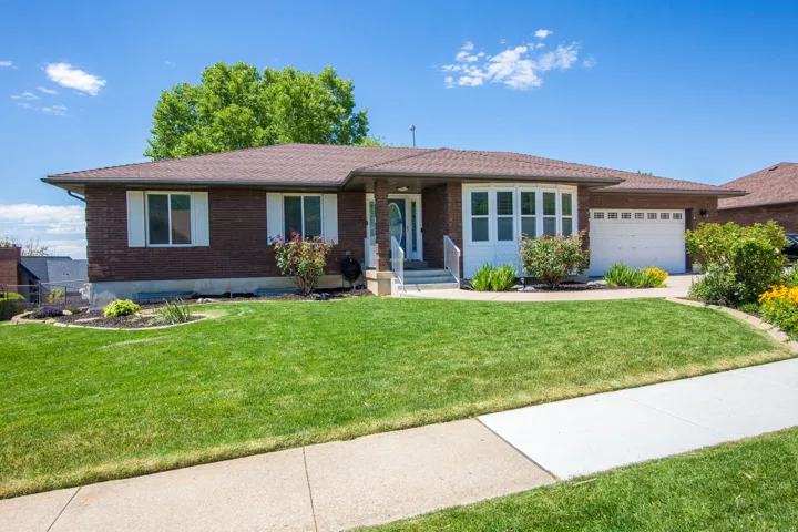 Brick exterior with a prominent bay window and white shutters