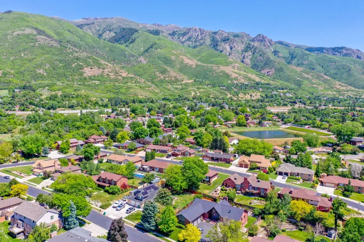 Expansive residential area featuring a variety of homes, mature trees, and paved streets
