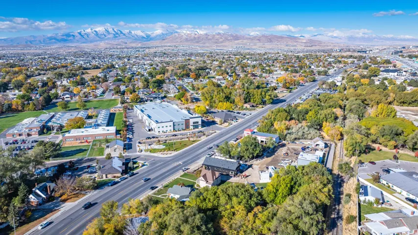 Expansive aerial perspective showcasing a developed urban area with surrounding natural landscapes