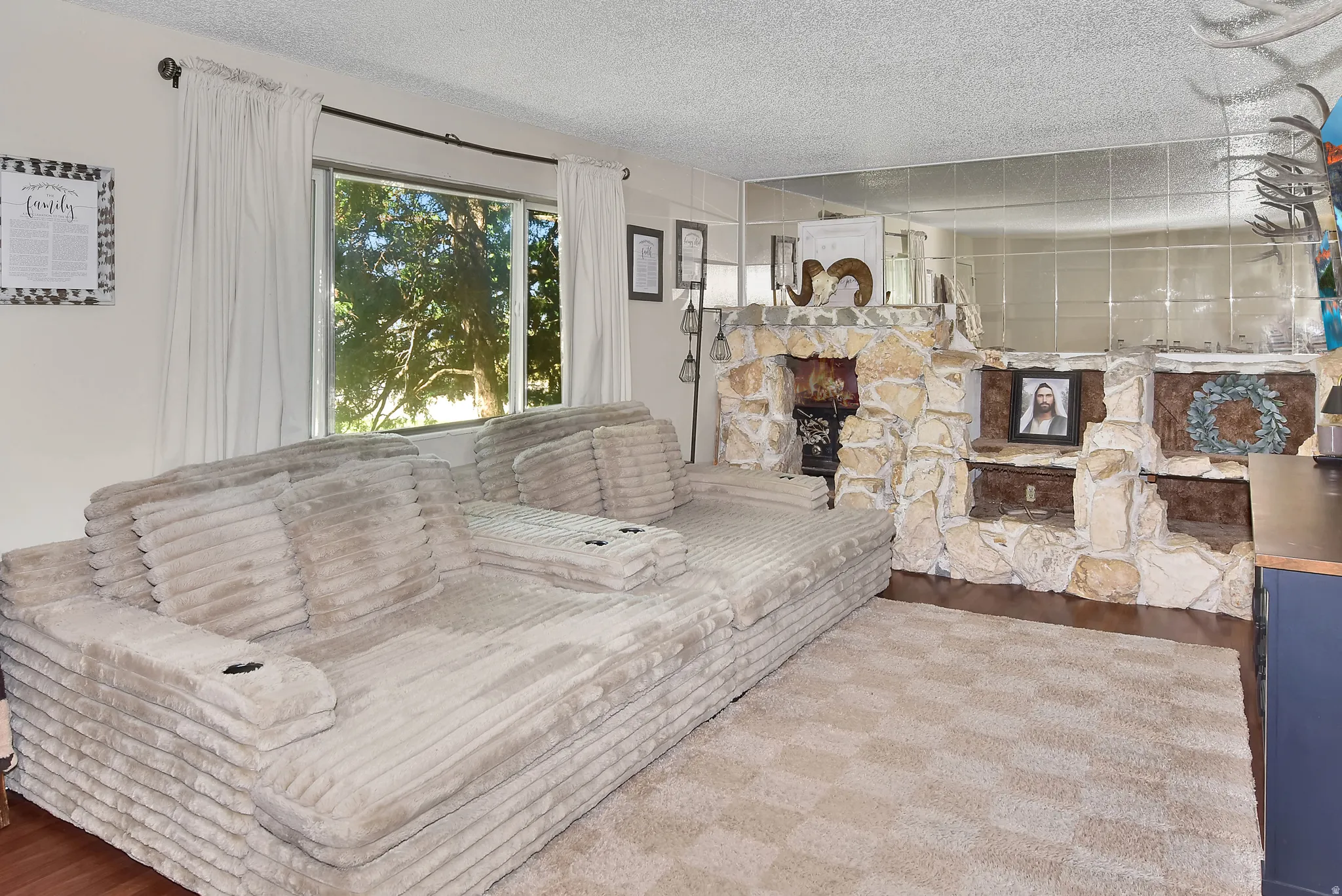 Living area featuring a stone-clad fireplace and hearth