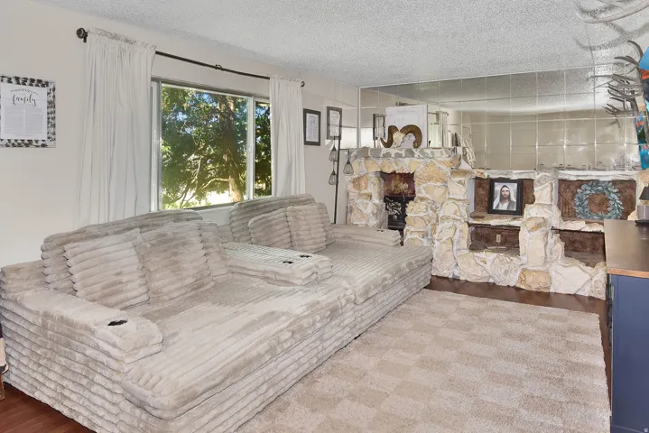 Living area featuring a stone-clad fireplace and hearth