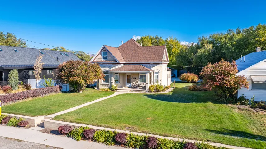 Traditional-style home featuring a covered front porch and dormer windows