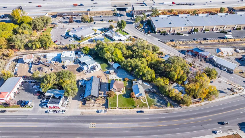 Aerial perspective showcasing a multi-building property with varied rooflines and surrounding mature trees
