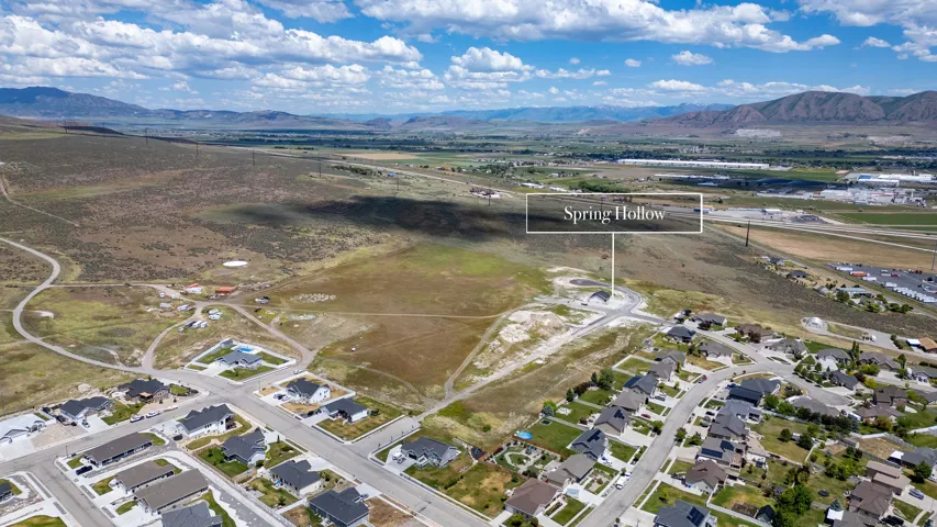 Aerial perspective showcasing a residential development with mountain backdrops