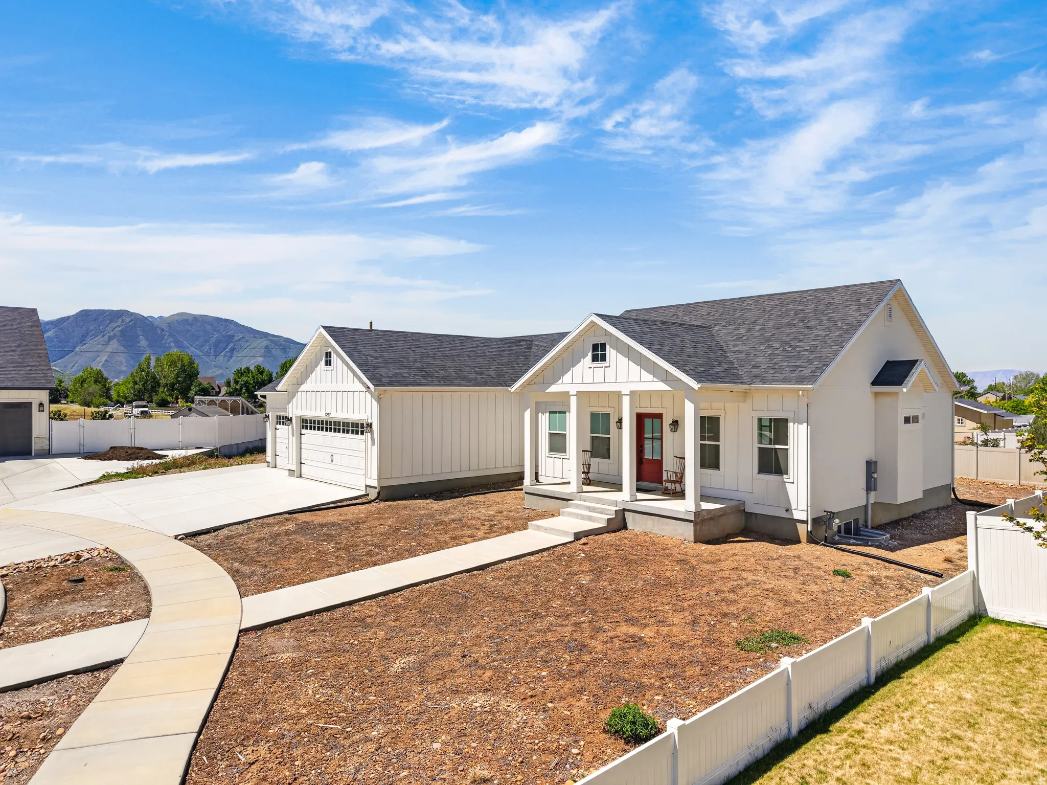 Contemporary farmhouse-style residence featuring white board and batten siding