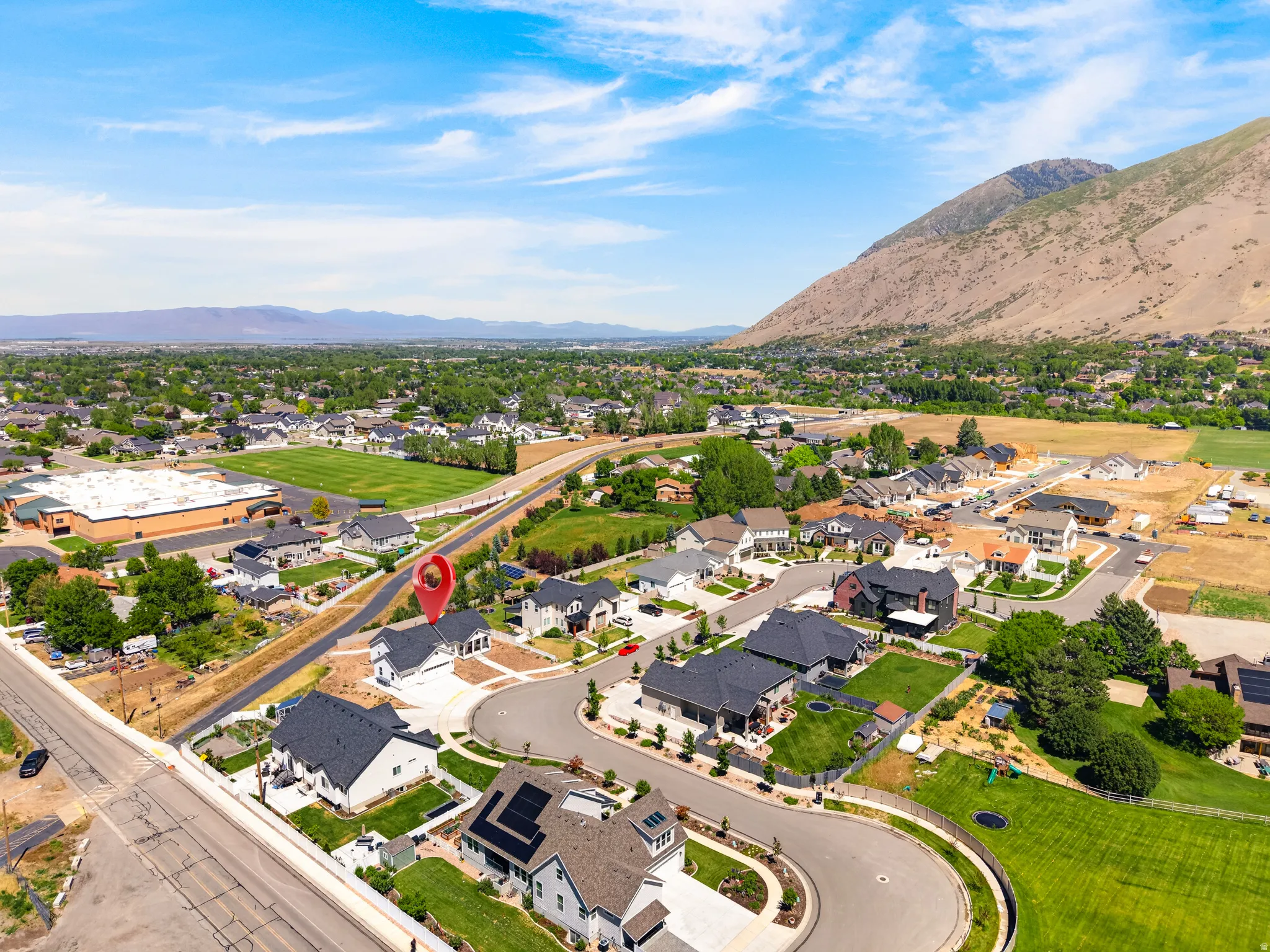 Modern residential community set against a mountainous backdrop