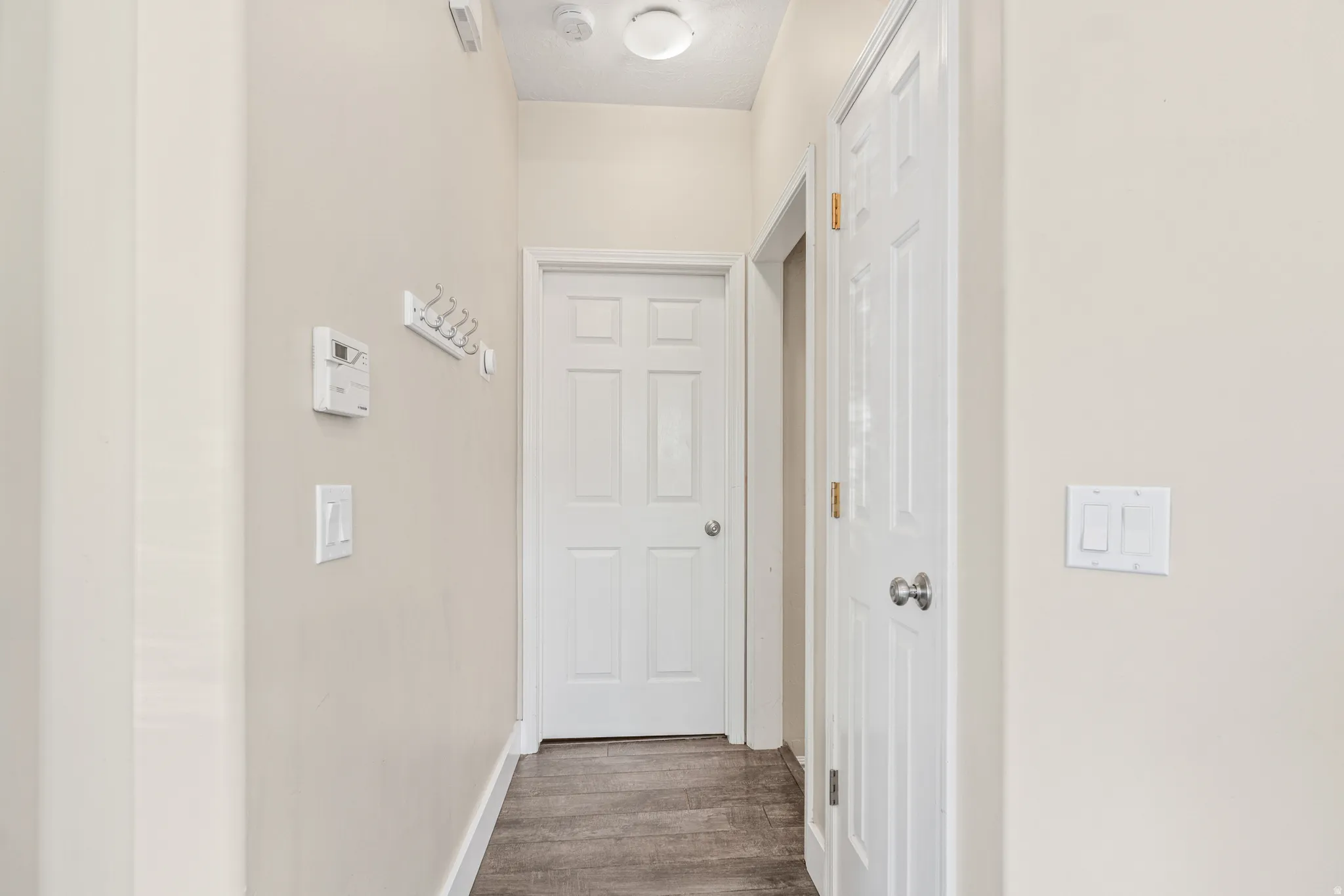 Wood-finish flooring with neutral wall tones and white trim