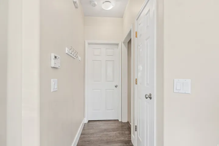 Wood-finish flooring with neutral wall tones and white trim