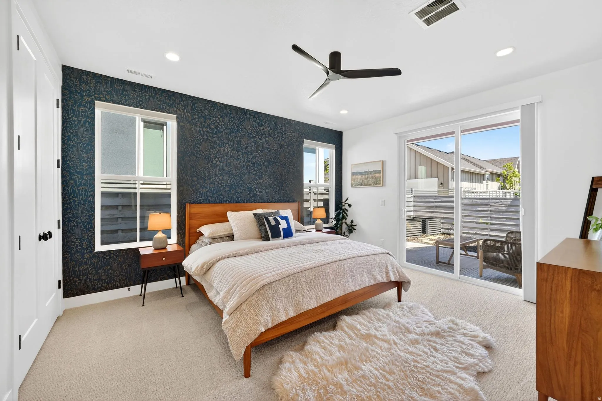 Carpeted room featuring a dark accent wall, recessed lighting, and a ceiling fan