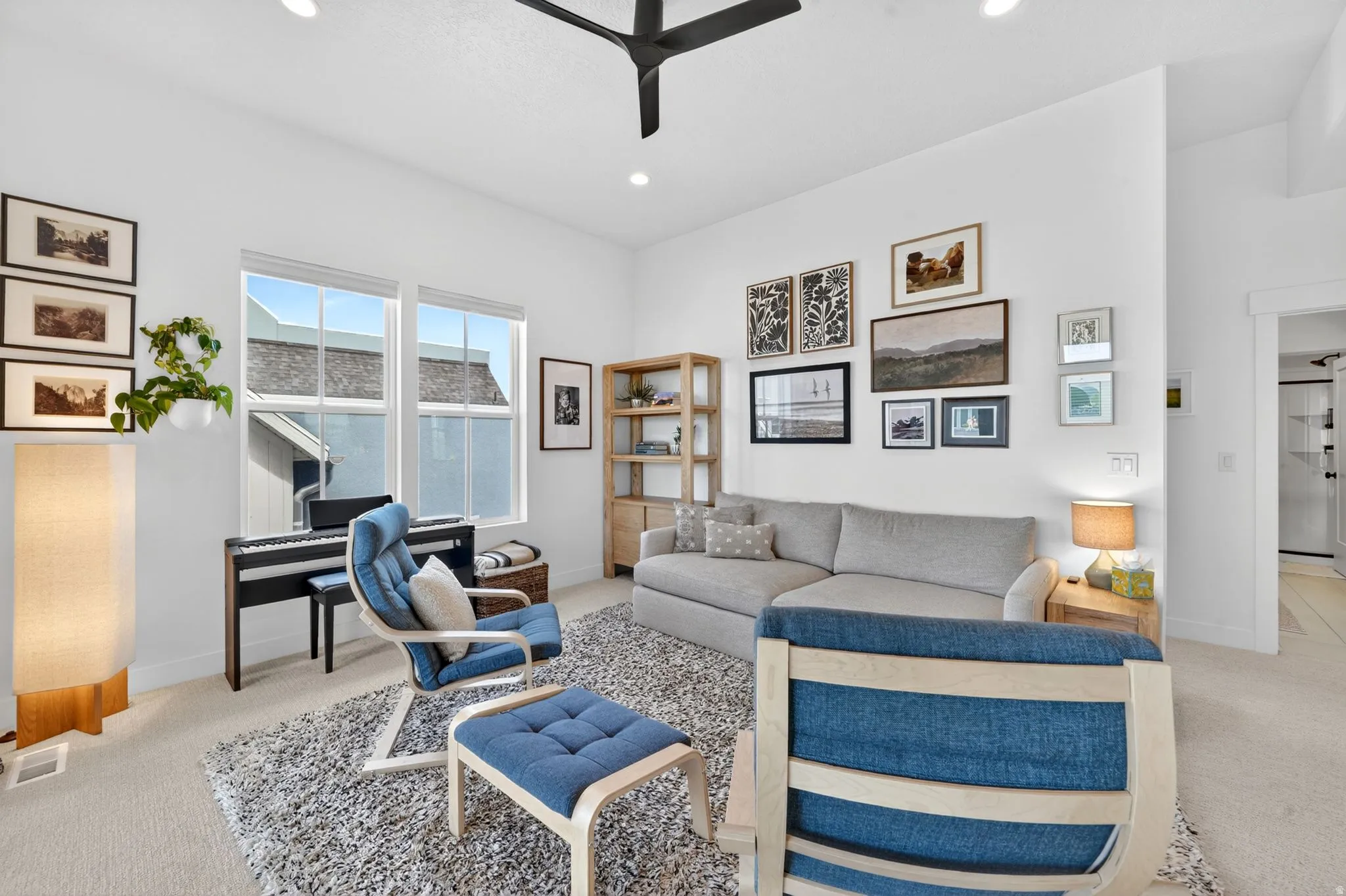 Light-filled living area featuring recessed lighting and a ceiling fan