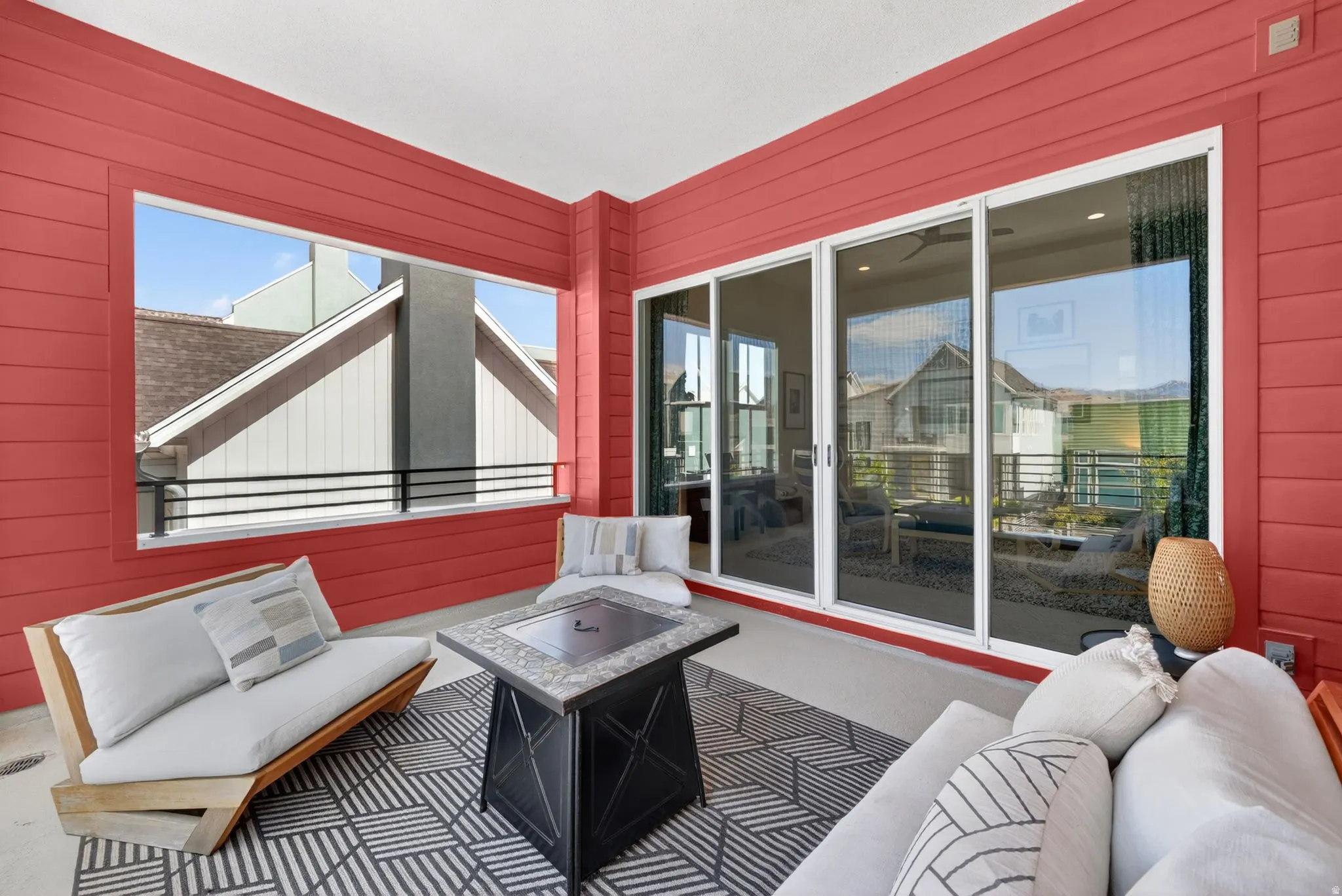 Covered outdoor patio featuring extensive red horizontal siding