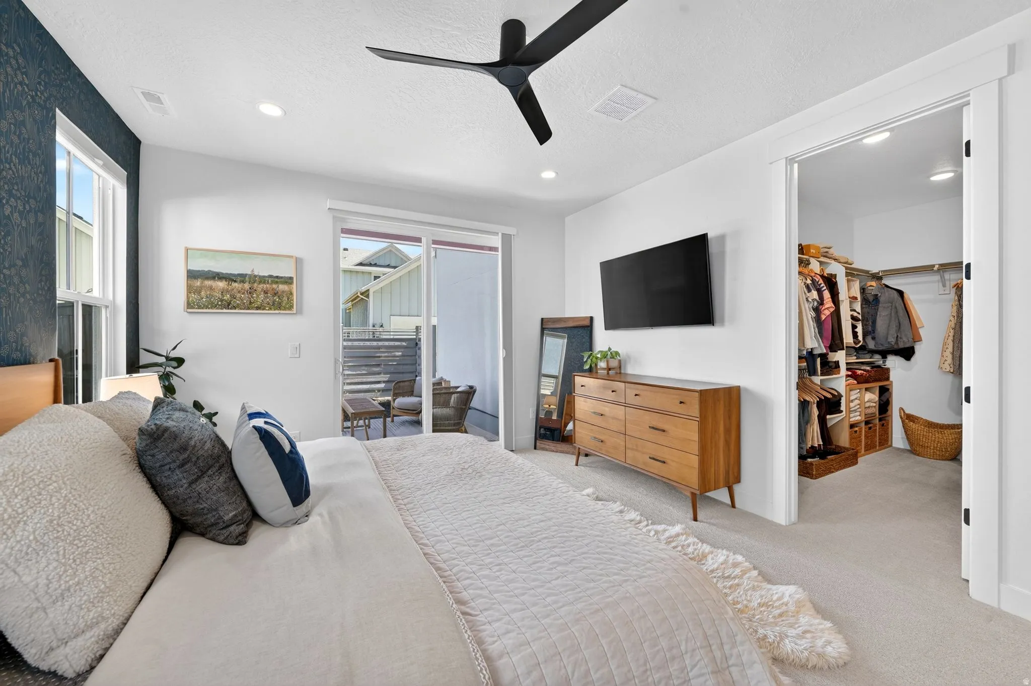 Bedroom featuring a textured accent wall, recessed lighting, and a modern ceiling fan