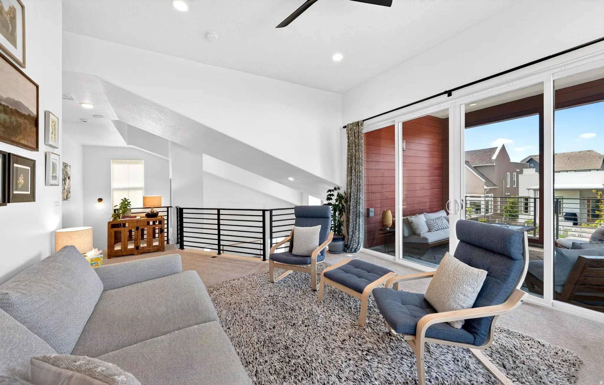 Bright loft space featuring a vaulted ceiling with recessed lighting and a ceiling fan