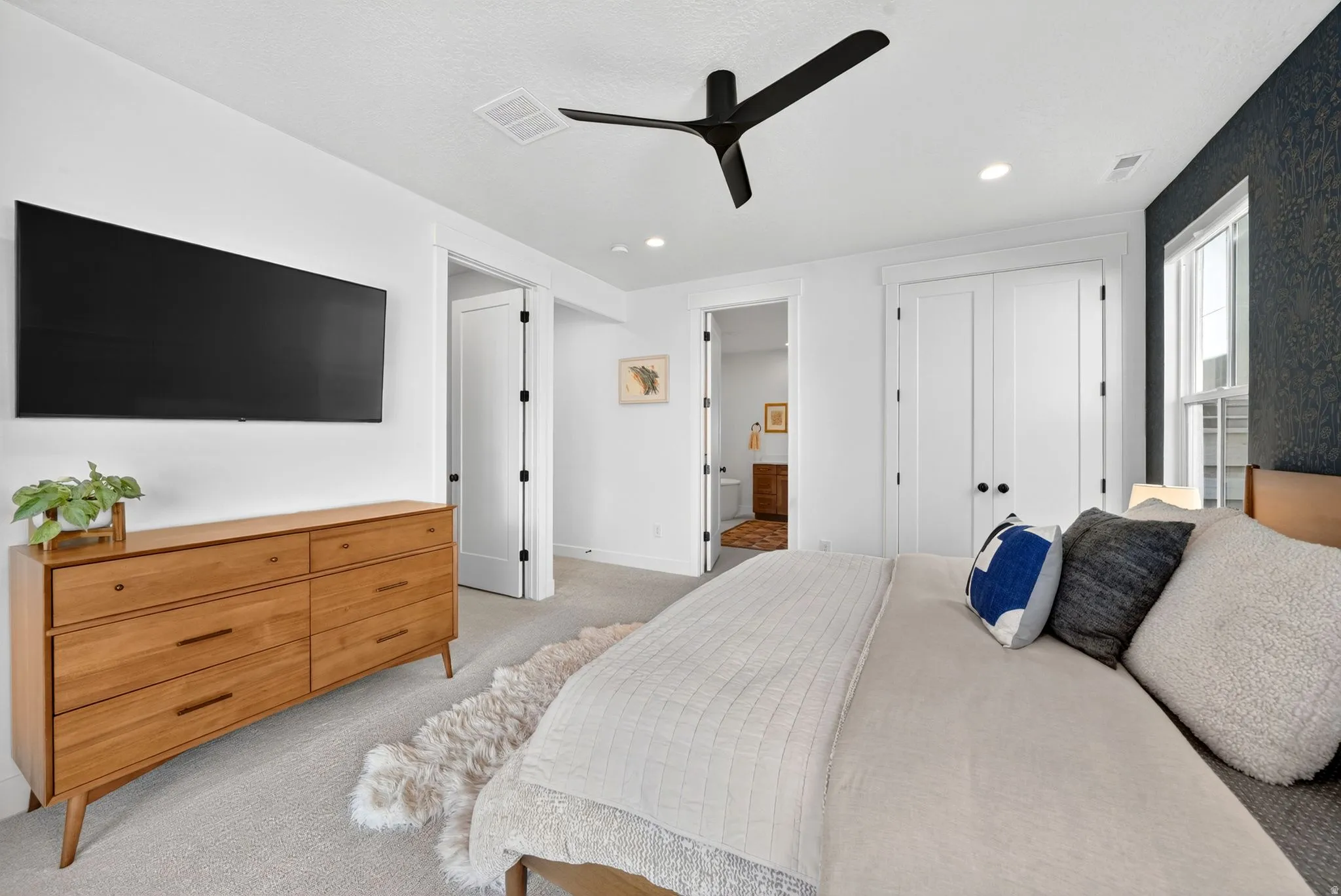 Bedroom featuring a modern ceiling fan, recessed lighting, and light-toned carpeting