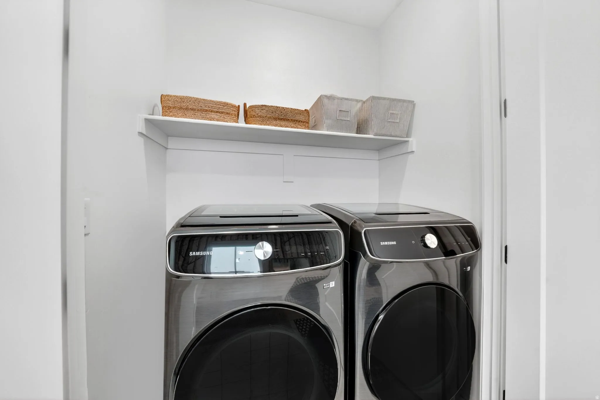 Dedicated laundry area featuring a white wall-mounted shelf