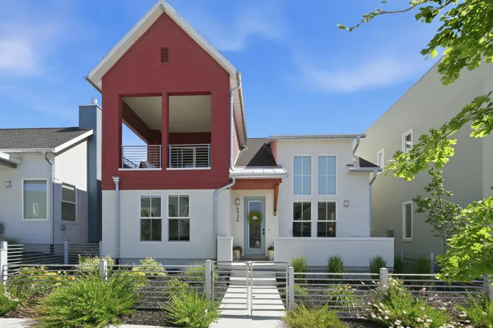Modern facade featuring red siding and white stucco