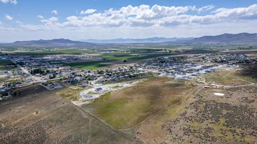 Expansive aerial perspective showcasing a residential development amidst a rural landscape