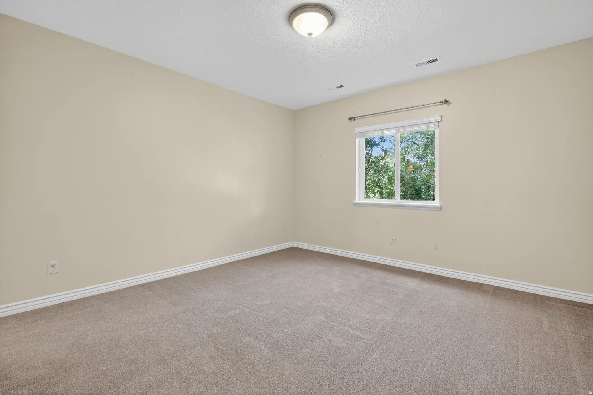 Neutral tone carpeting paired with light-colored walls and white trim