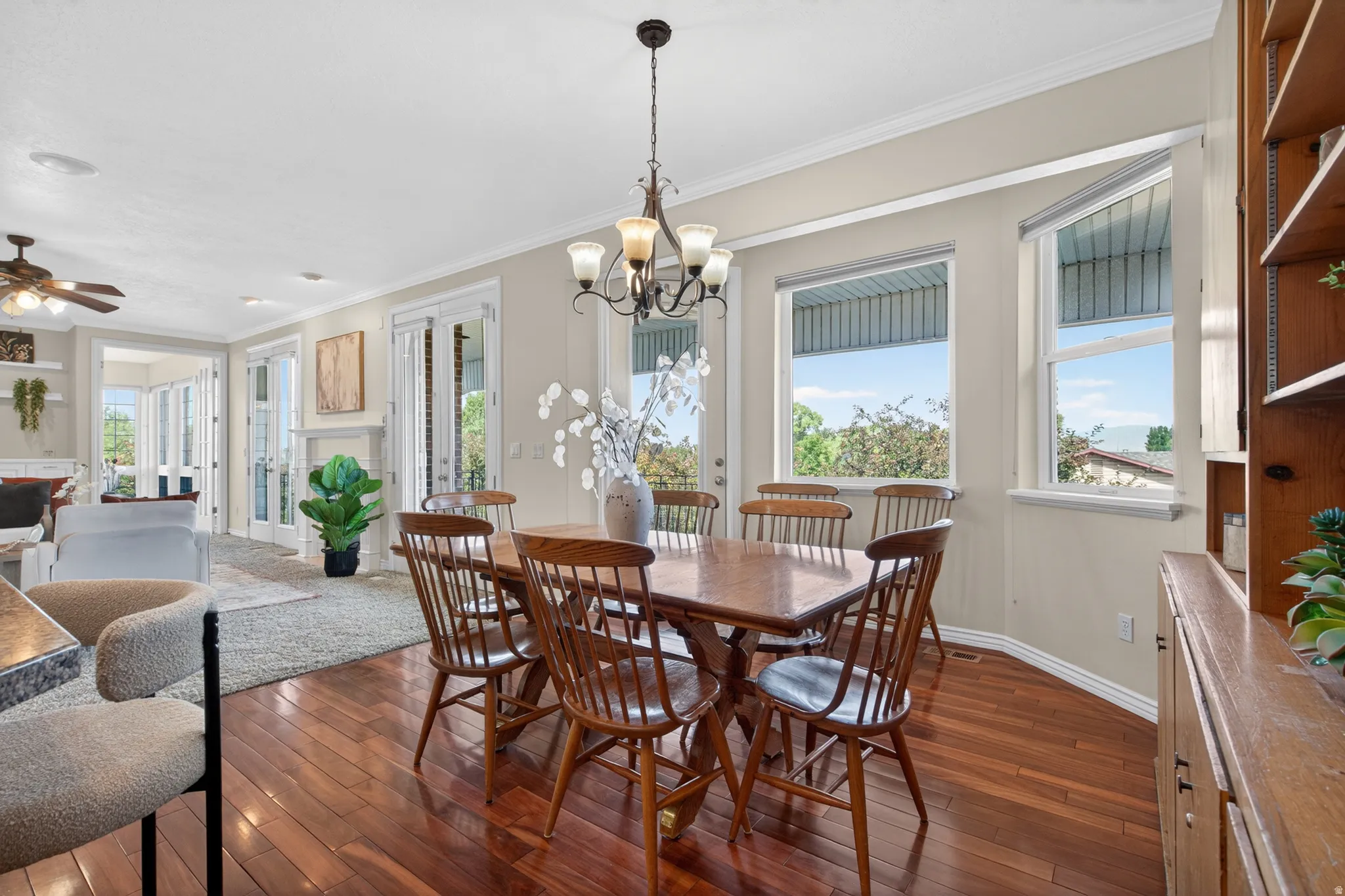 Dining area featuring wood-finish flooring, a chandelier, and multiple windows