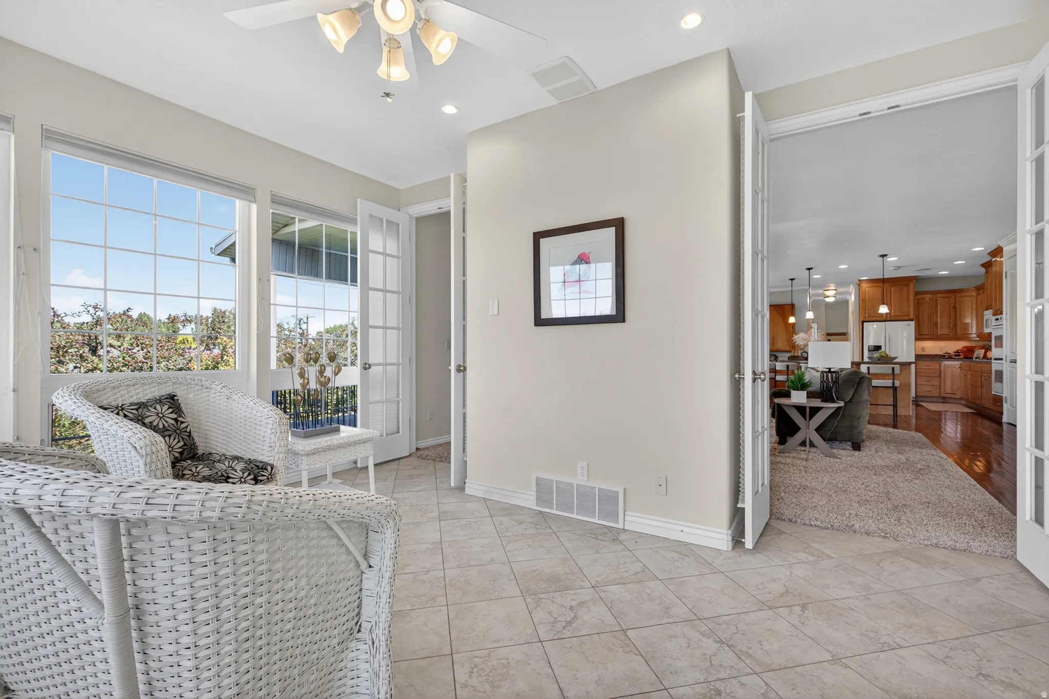Sunroom featuring grid-pattern windows and light-toned tile flooring