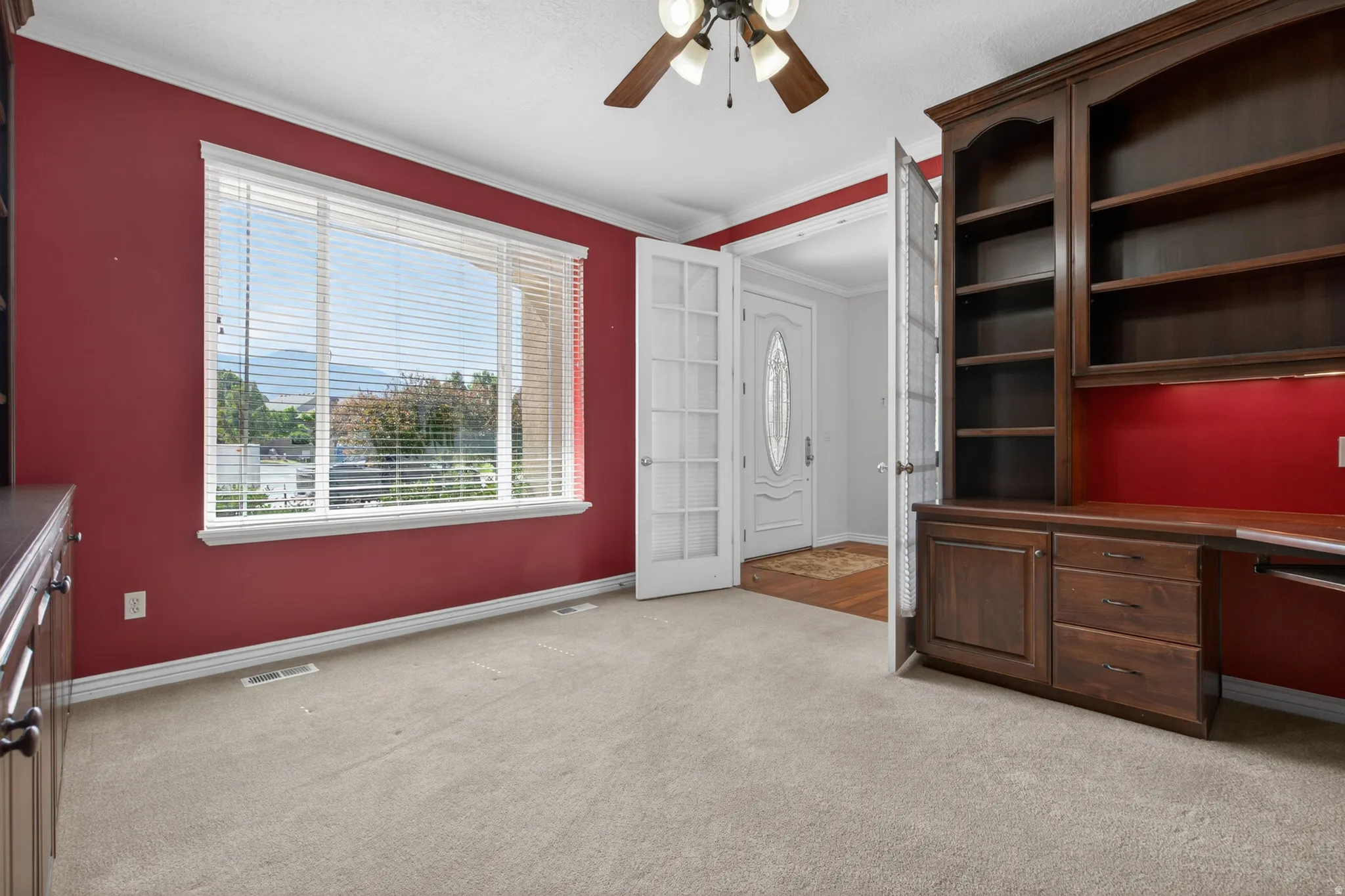 Built-in dark wood cabinetry with integrated shelving and desk space
