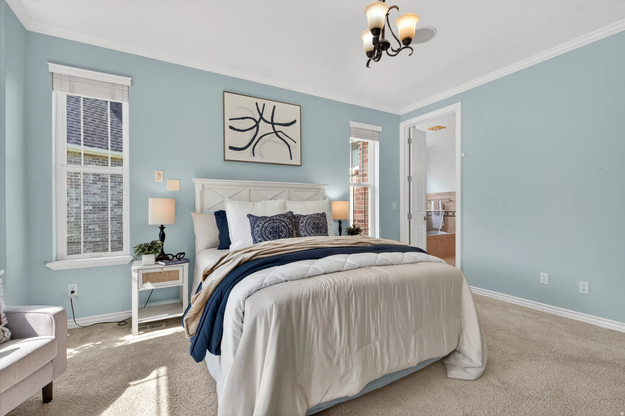 Carpeted room with light blue walls and white crown molding