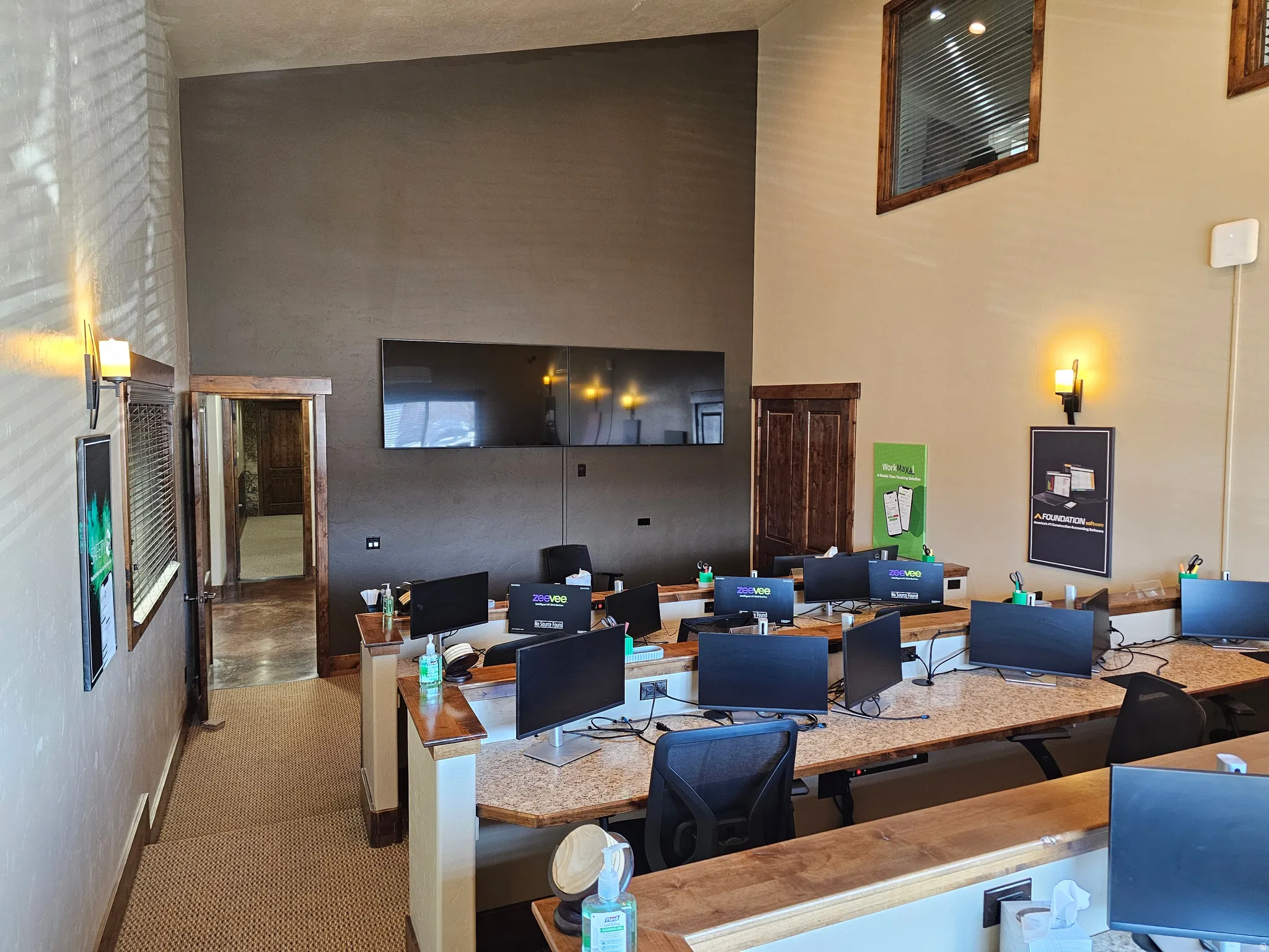 Commercial workspace featuring high ceilings and sconce lighting