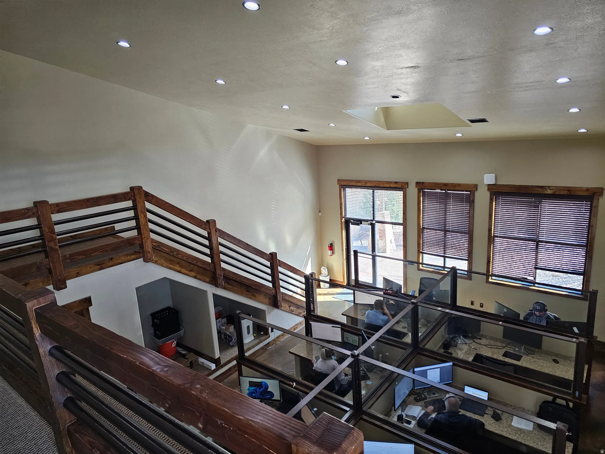 Multi-level interior featuring recessed lighting, a skylight, and large windows with blinds