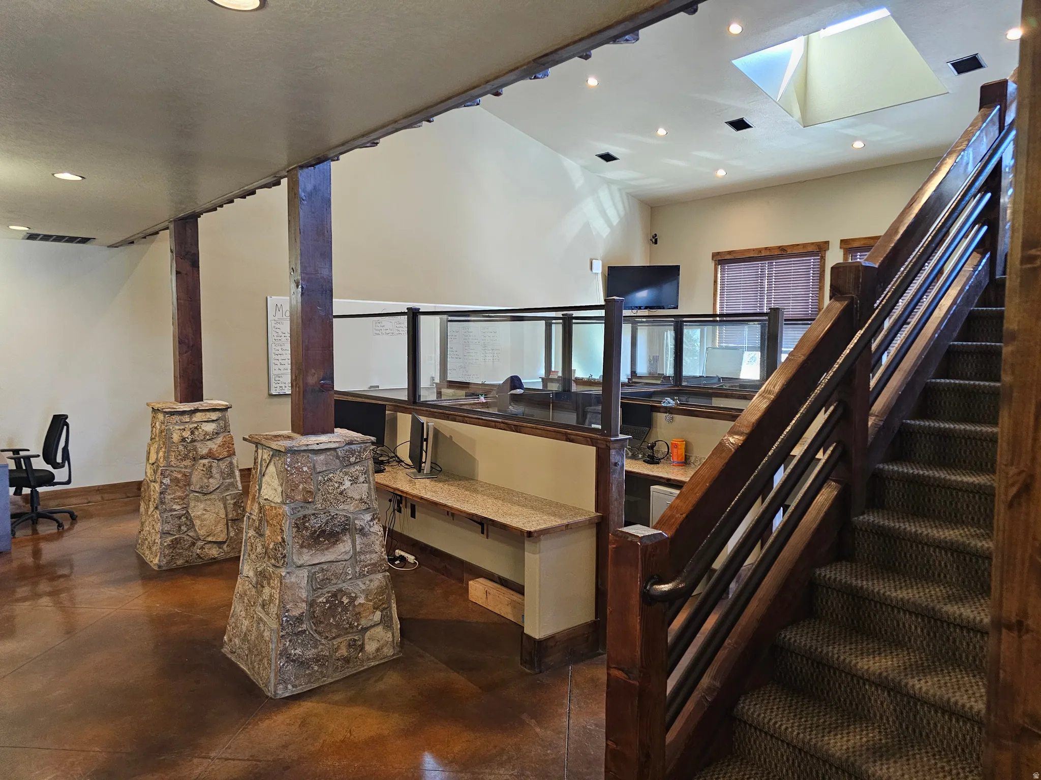 Carpeted staircase with dark wood-finish railing and metal spindles