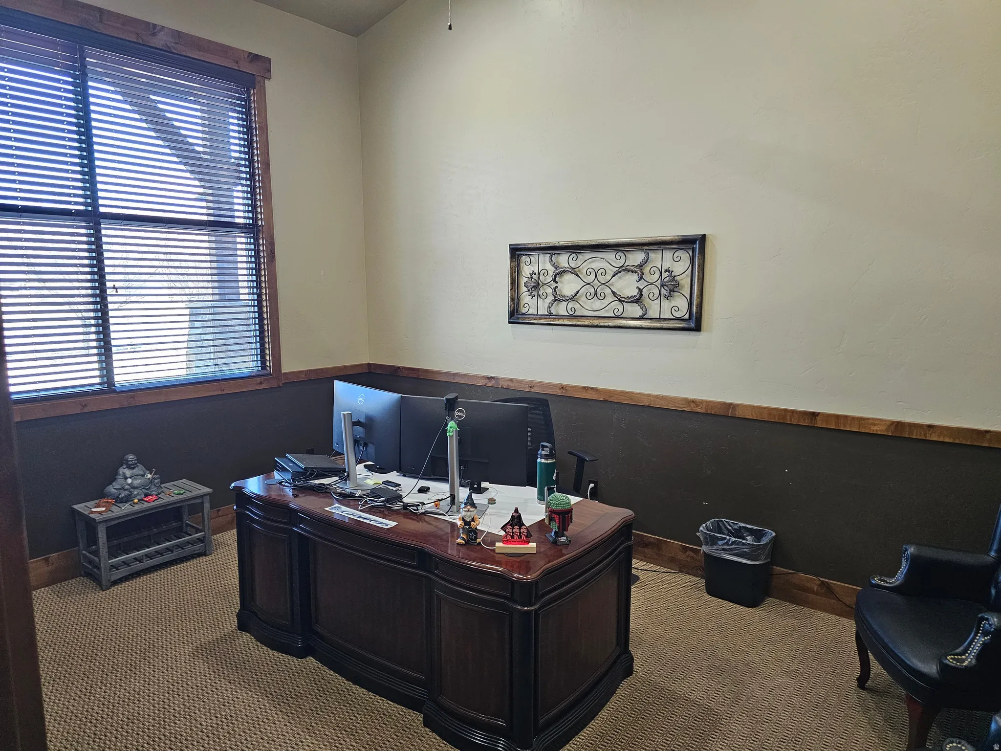 Room featuring a large window with horizontal blinds and wood-finish trim, complemented by textured walls with a two-tone paint scheme and a wood-finish chair rail
