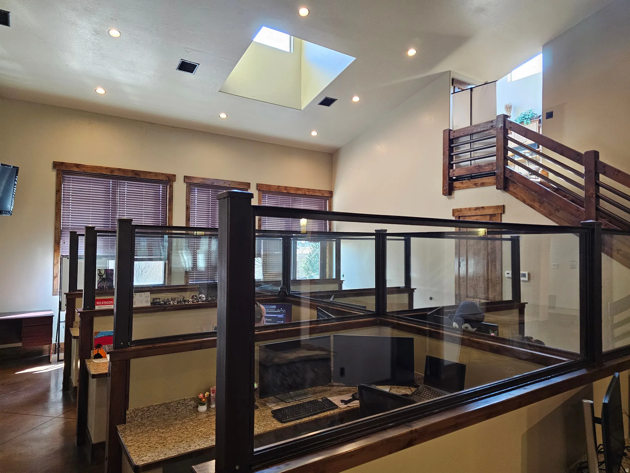 Vaulted ceiling with a central skylight and recessed lighting