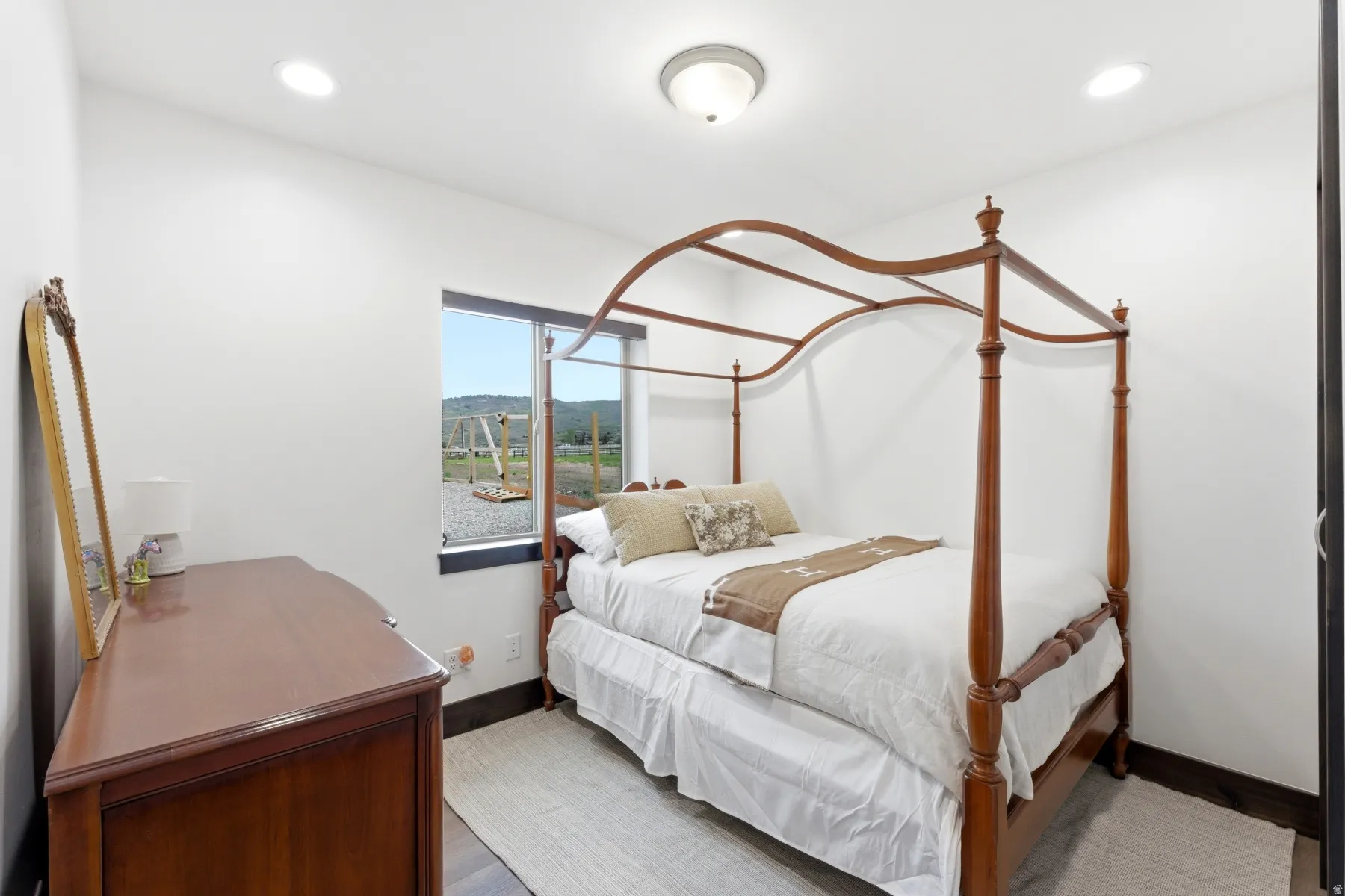 Bright room featuring white walls and dark trim, recessed lighting, and a single window